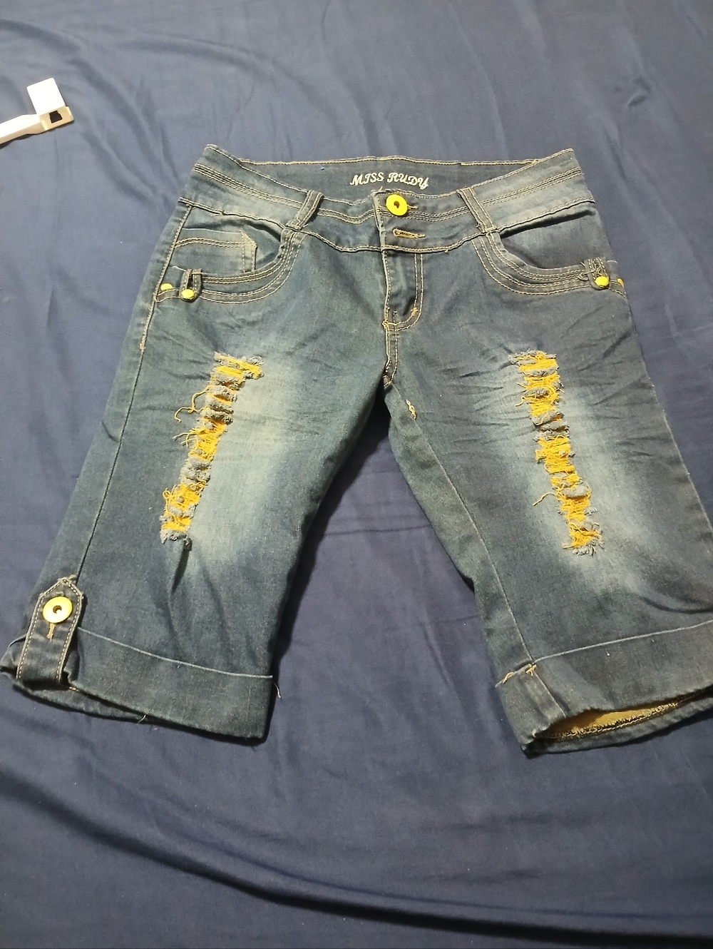 Miss Rudy Distressed Denim Knee Shorts in Blue with Yellow Accents